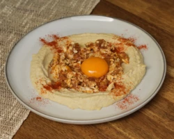 Hummus, Egg, Scrambed egg, Tahini, Pepper Plate of hummus with egg and spices